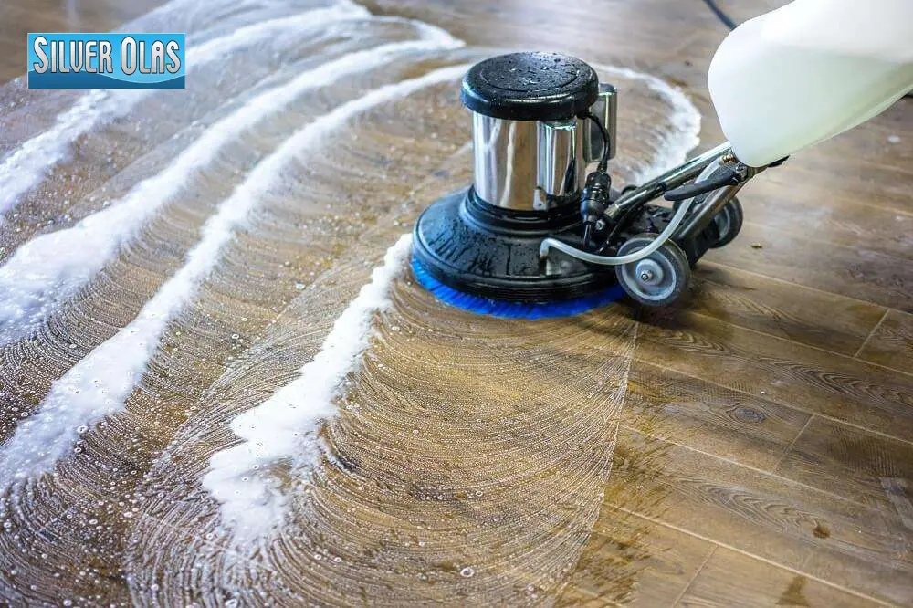 Professional floor scrubbing machine using best wood floor cleaners to restore shine on hardwood floors.