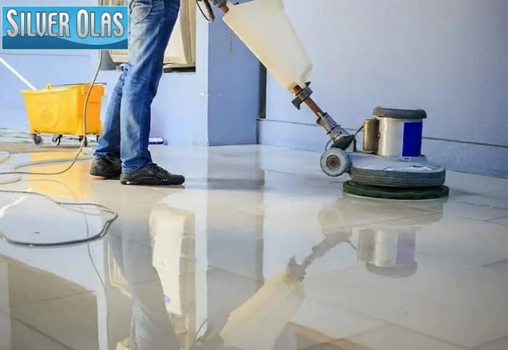 Professional Tile Cleaning service using a floor buffer on shiny, reflective large-format tiles.