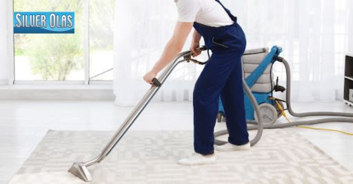 Professional cleaning technician performing expert rug cleaning in a modern home