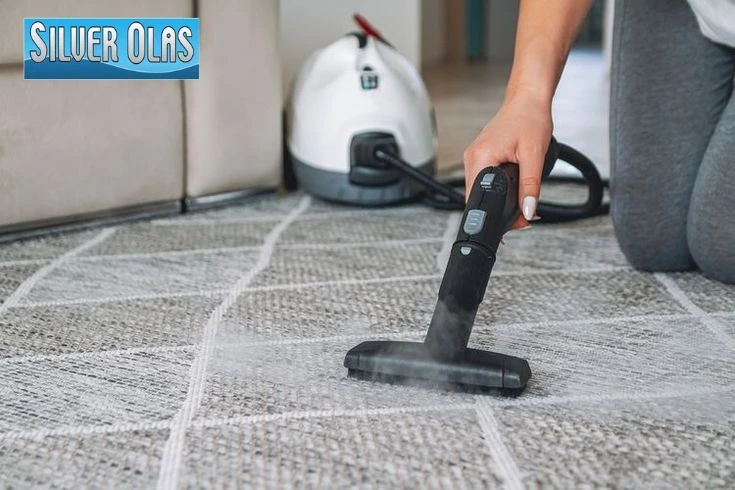 Professional technician performing steam carpet cleaning in a Murrieta home