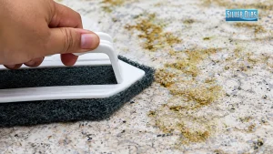 Scrubbing dirty terrazzo floor using specialized Tile and Stone Cleaning Services.