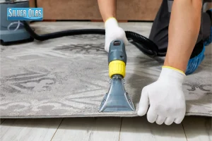 Professional technician vacuuming patterned area rug for rug cleaning Murrieta.
