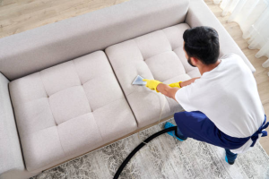 Professional steam cleaning a beige fabric sofa for Upholstery Cleaning in Vista.