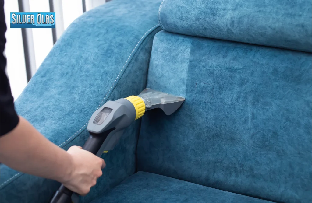 Steam cleaning nozzle extracting dirt from blue sofa for upholstery cleaning vista ca.