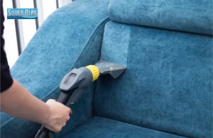 Steam cleaning nozzle extracting dirt from blue sofa for upholstery cleaning vista ca.