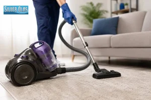 Professional vacuuming living room rug representing carpet and rug cleaning services.